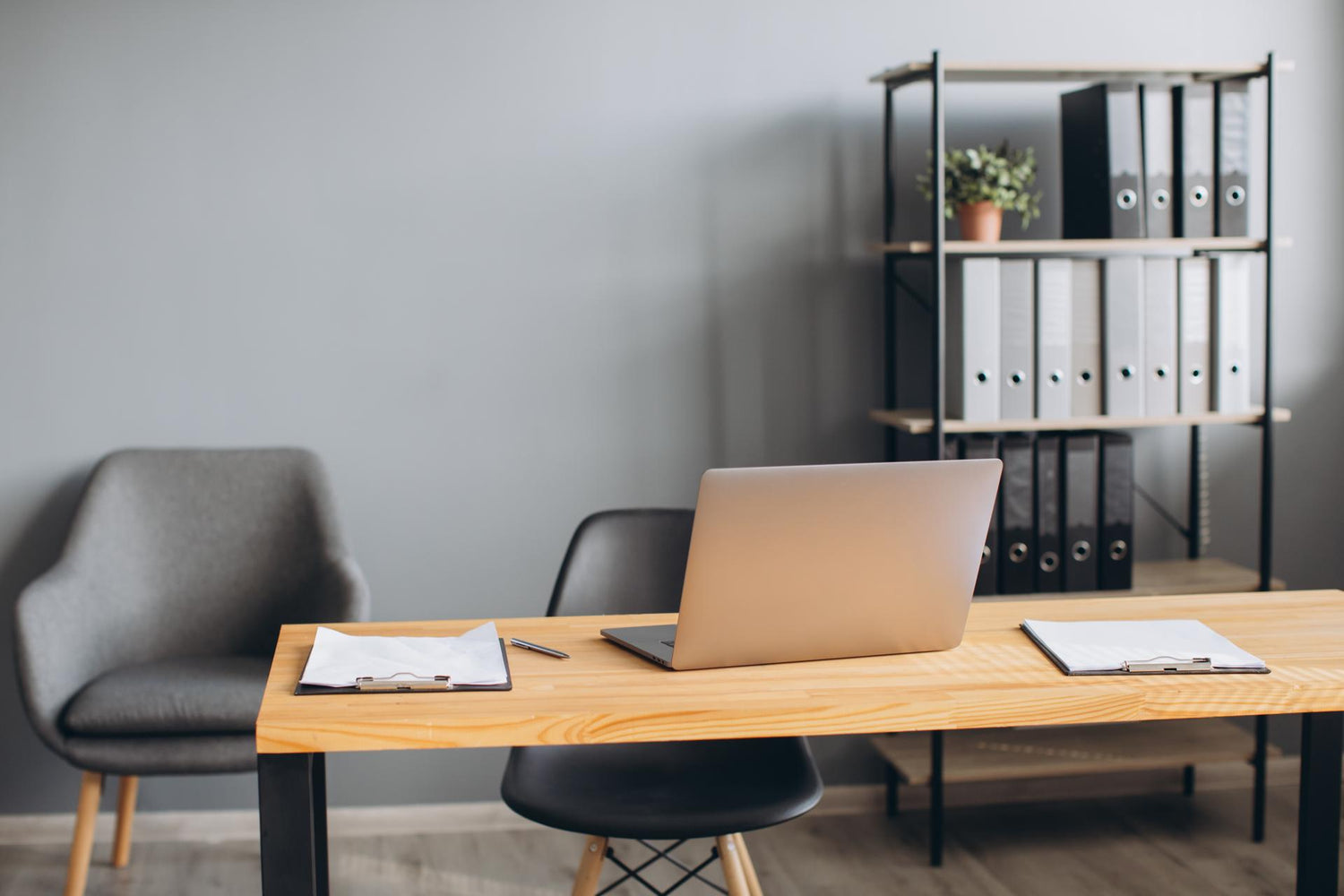 Stylish workspace with laptop, stationery, phone and documents in the office. Work desk concept.
