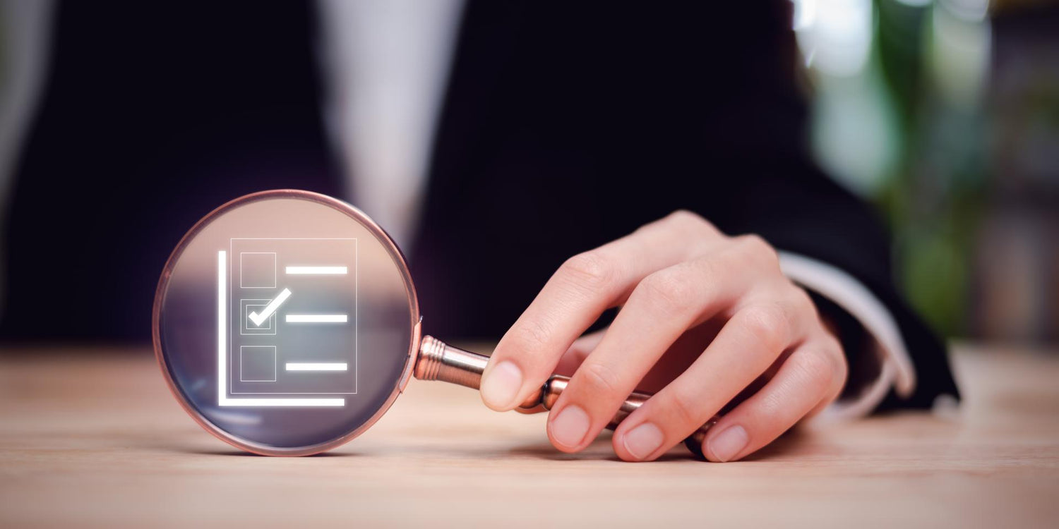 Businessman holding a magnifying glass and showing a marking concept on survey topic ,Auditing and evaluating the quality and efficiency of personnel ,Checklist with checkmarks and checkboxes