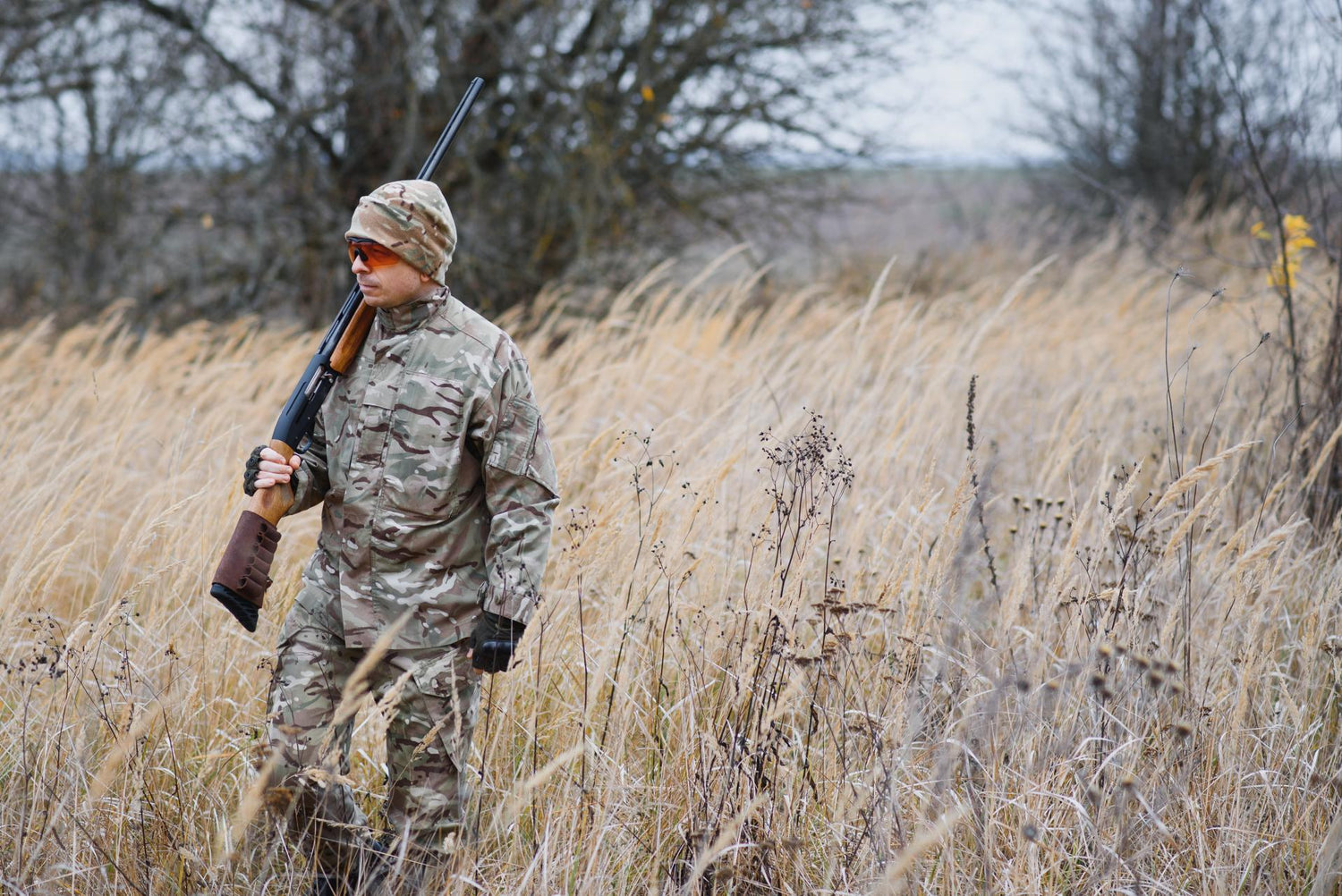 Hunter in uniform with a hunting rifle. Hunting Concept.