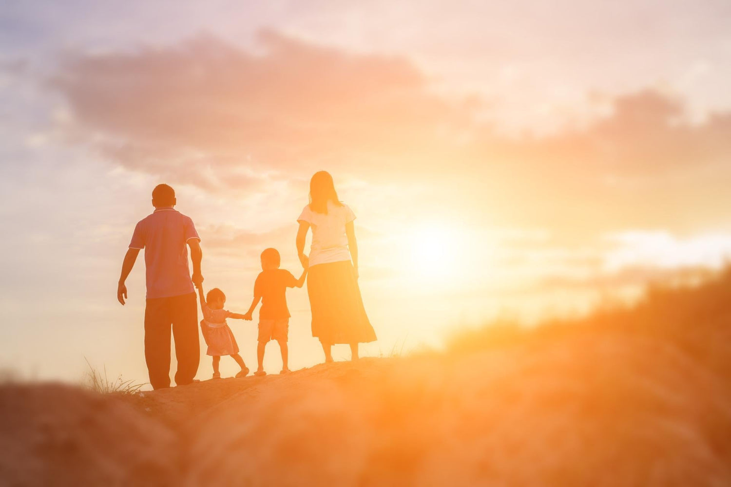 Happy family dancing on the road in the sunset time. Evening party on the nature