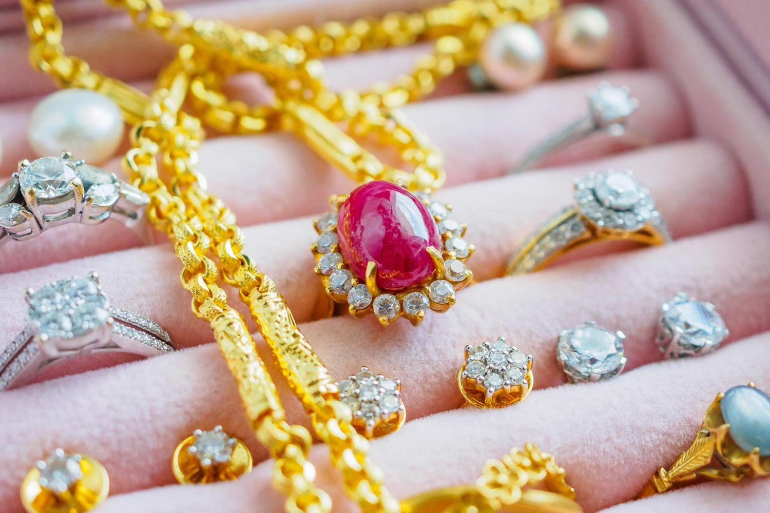 Gold and silver diamond gemstone sapphire ring necklaces and pearl earrings in luxury jewelry box