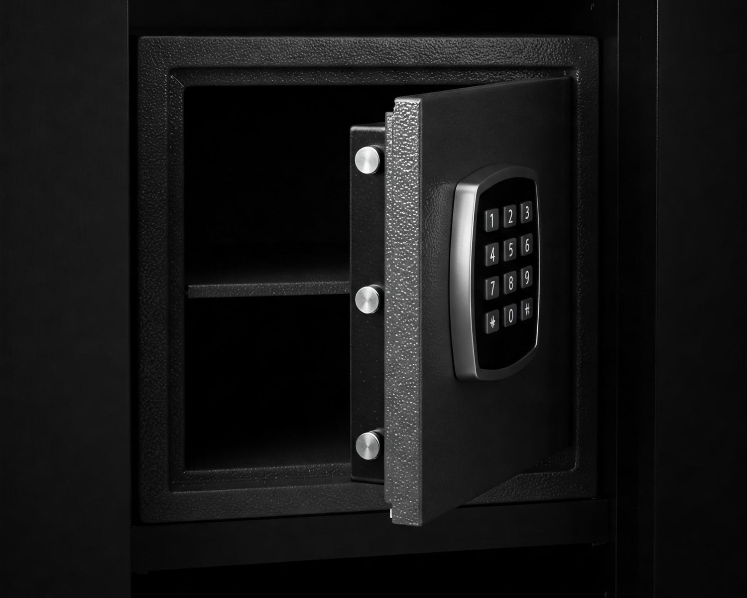 Metal safe box in closet. Small narrow safe for keeping money or valuables in the hotel. Open safe door with buttons for entering a password. Compact strongbox inside cabinet. Empty safe.