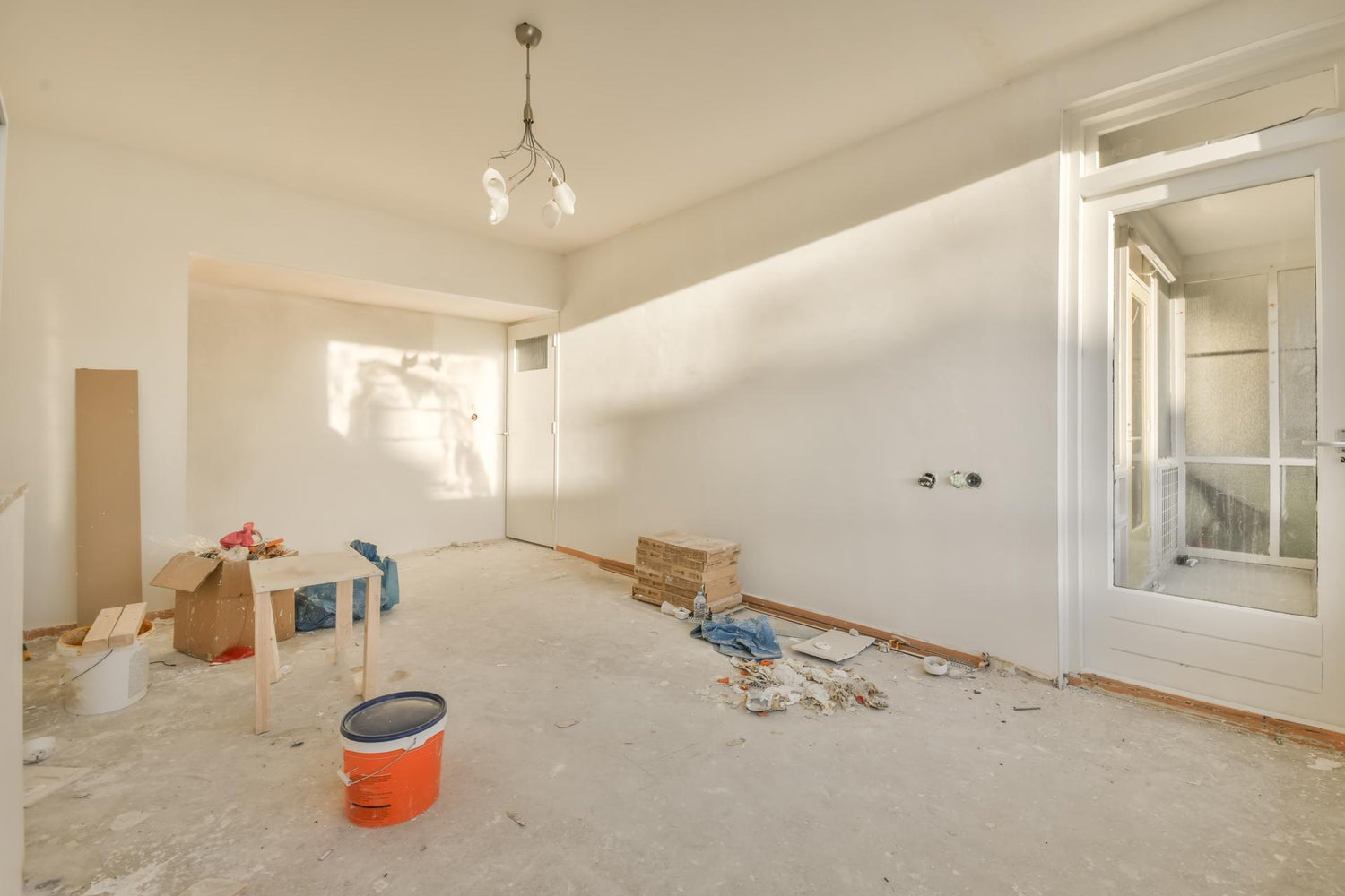 An empty room with a door and a table