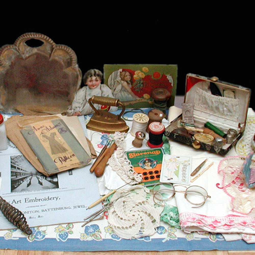 Collection of vintage sewing and craft items on a table