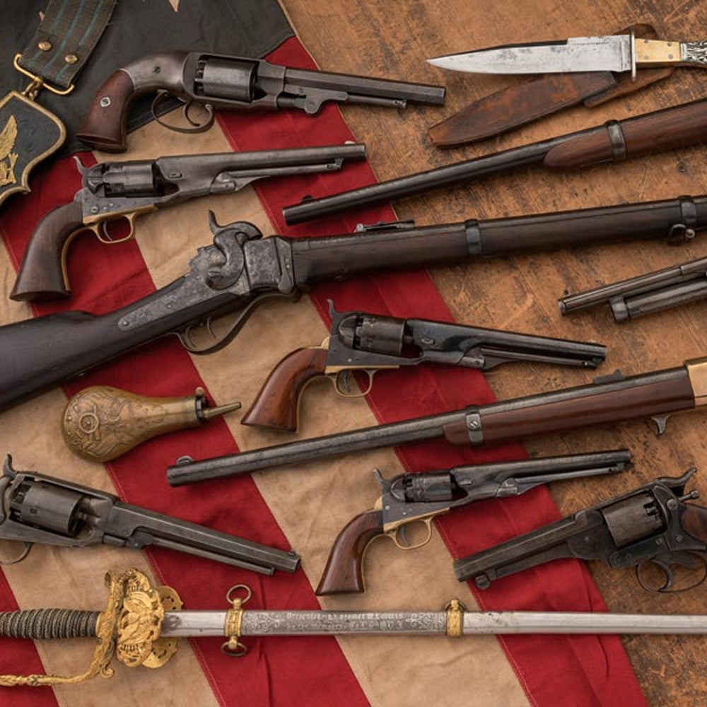 Collection of vintage firearms and a sword on an American flag background